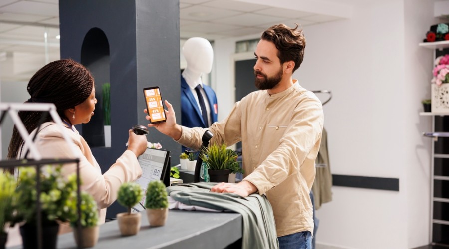 Customer using a digital loyalty app on their mobile in a clothes store