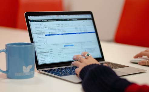 Photo of a Cyber-Duck employee viewing SEO data on a laptop in the office