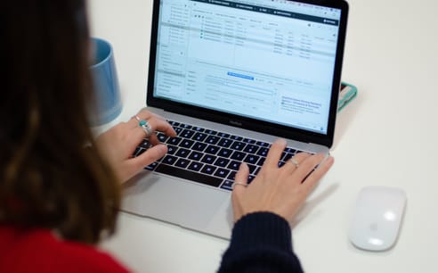 Photo of a Cyber-Duck employee viewing marketing data on a laptop